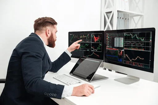 Trader reviewing forex market charts.